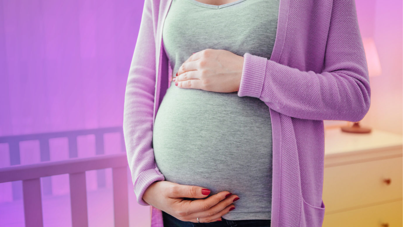 white women holding her belly with two hands