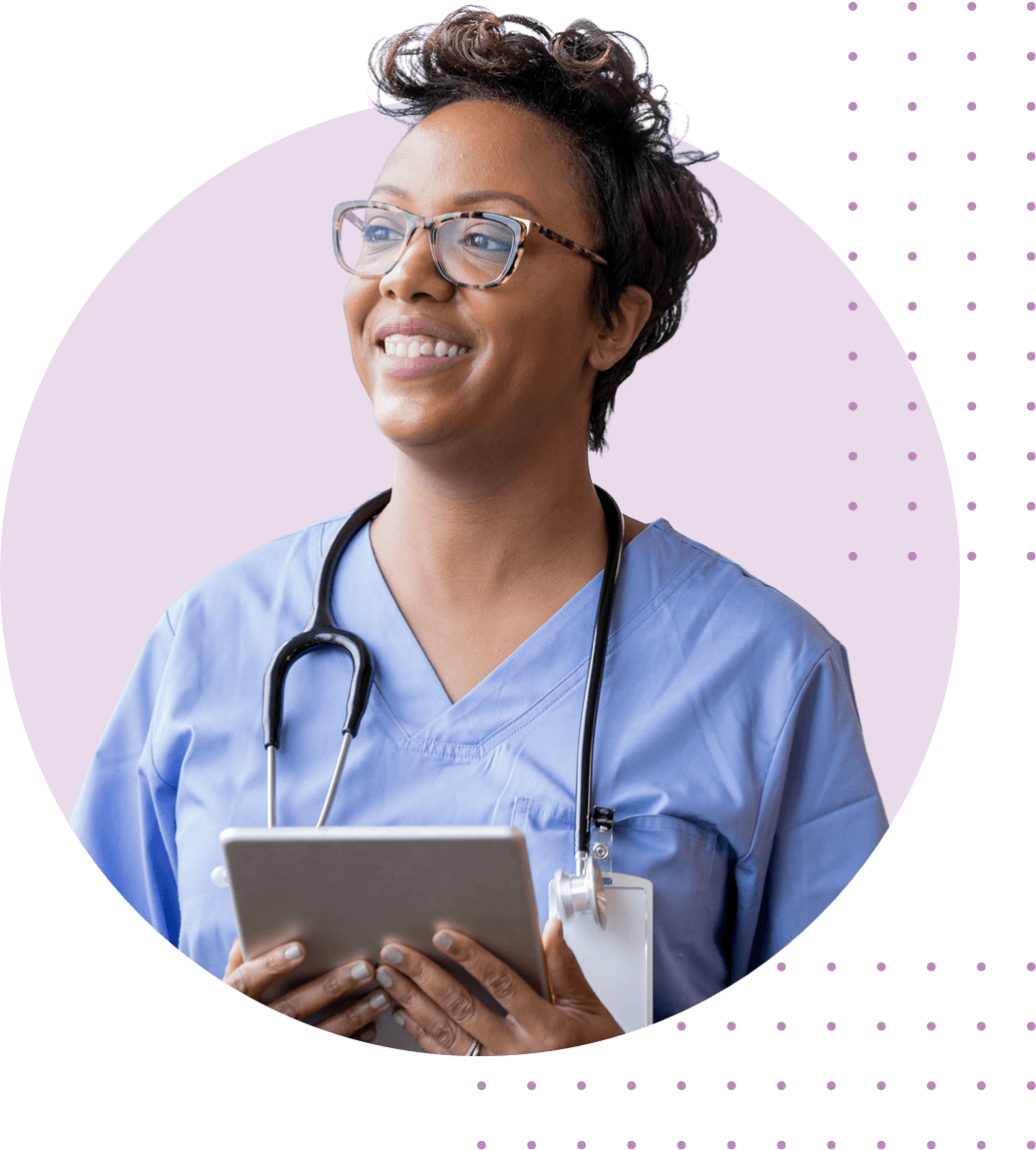 female nurse smiling and holding a tablet