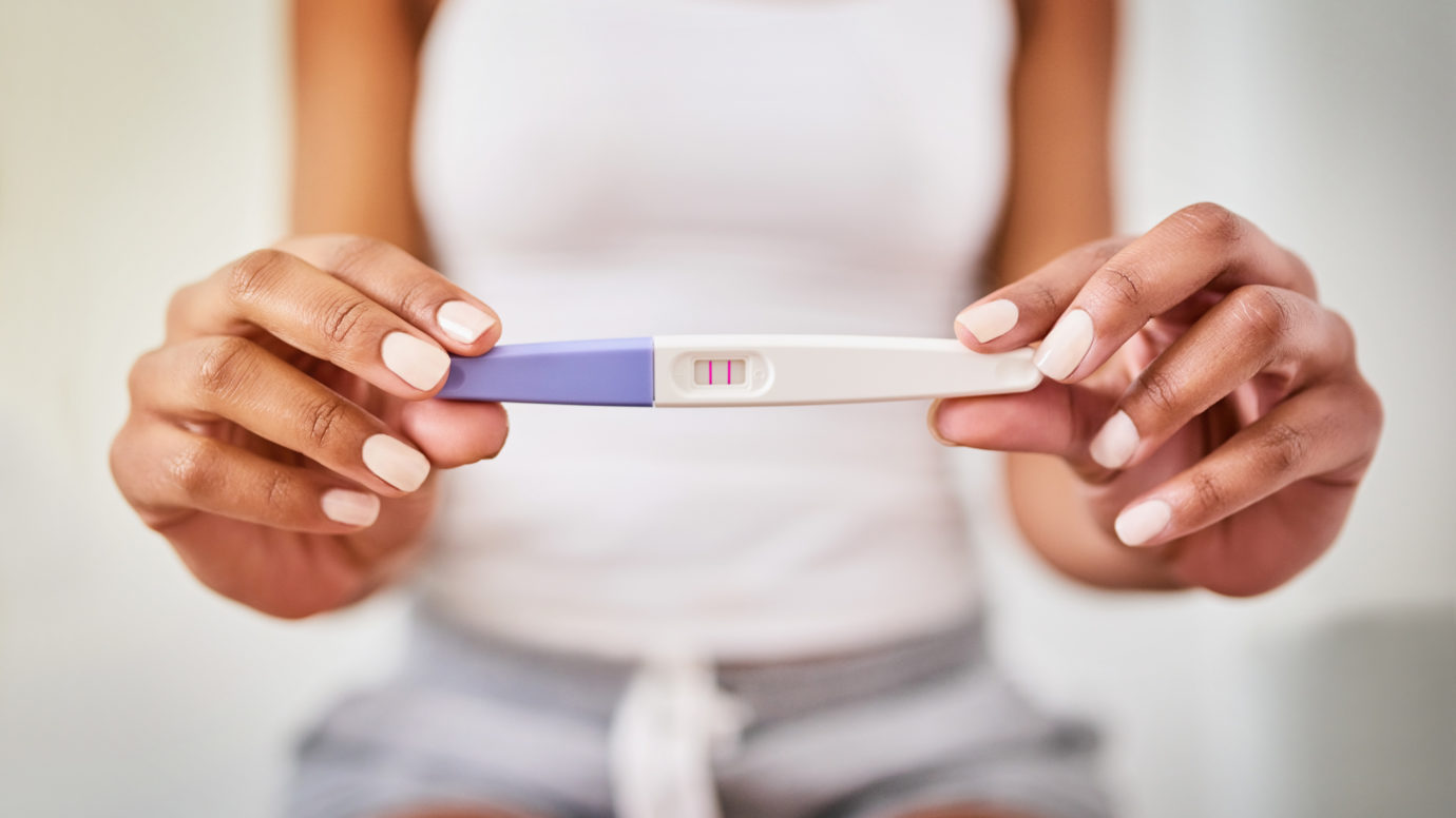 black women showing results from pregnancy test