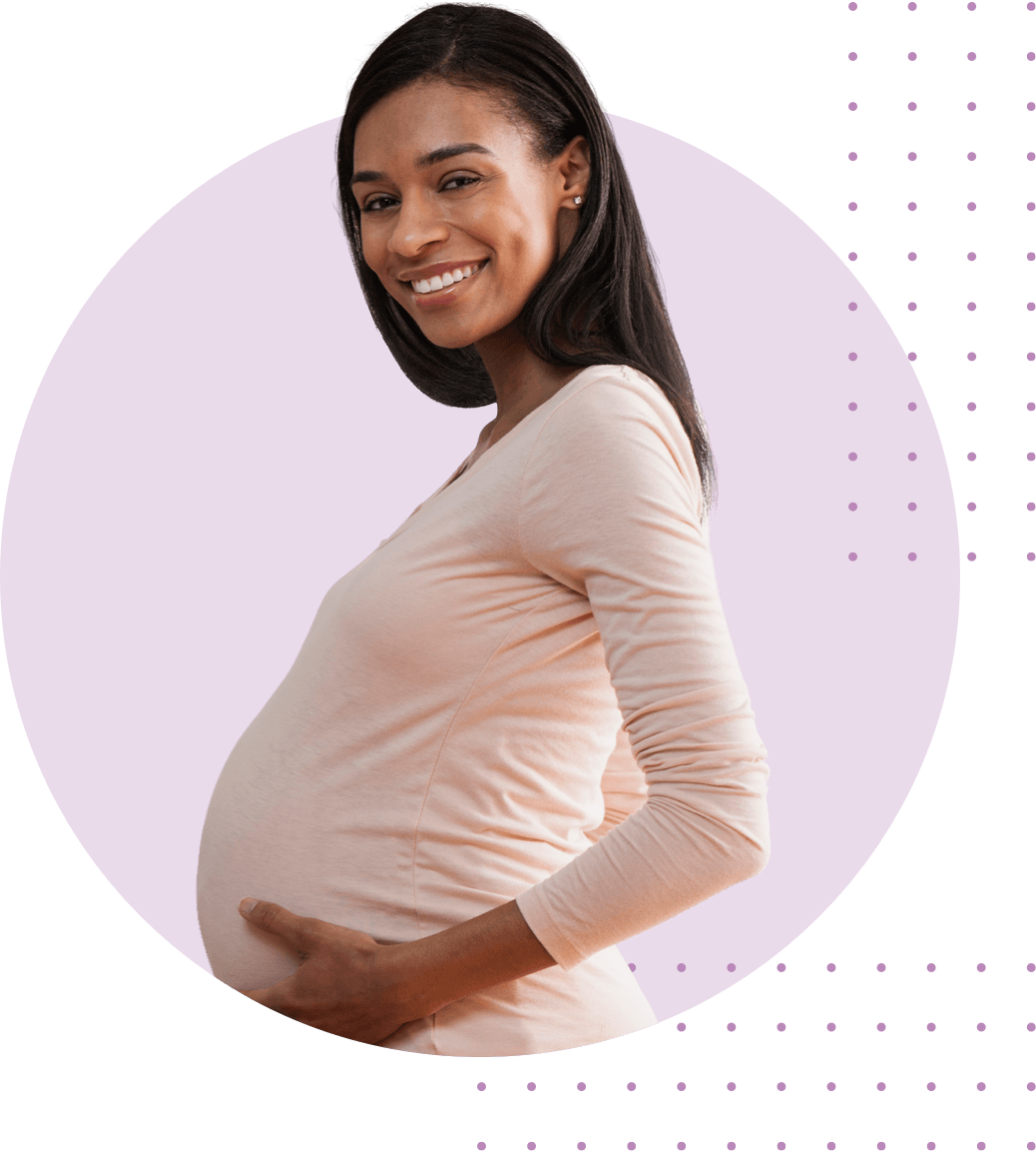 Young black pregnant women holding belly with two hands