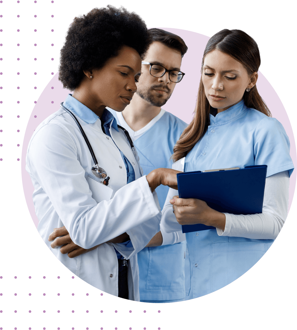 a doctor and two nurses looking at clipboard