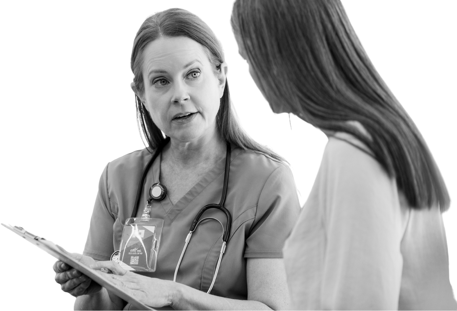 Two physicians discussing their paperwork about a patient