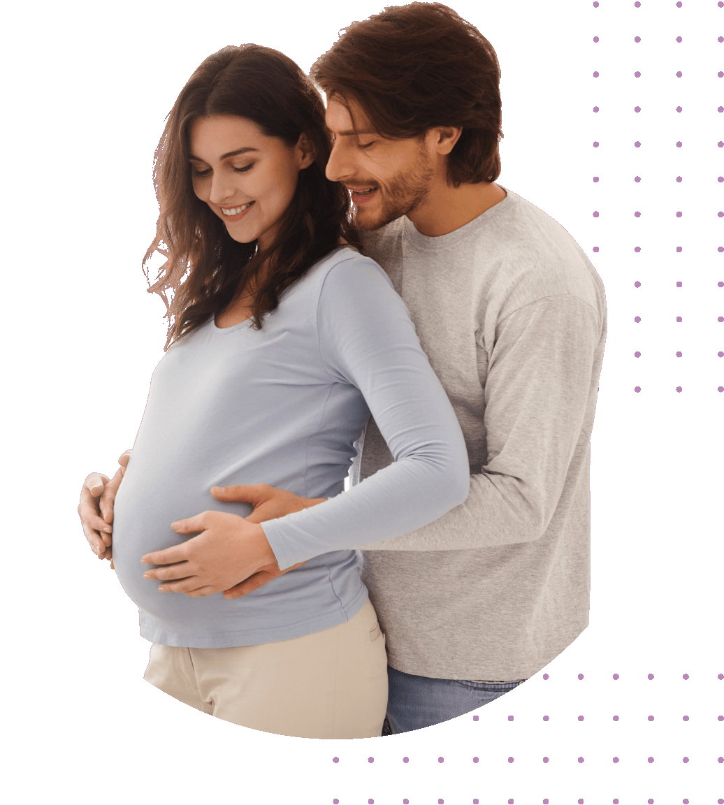 white male holds pregnant women's belly up from behind