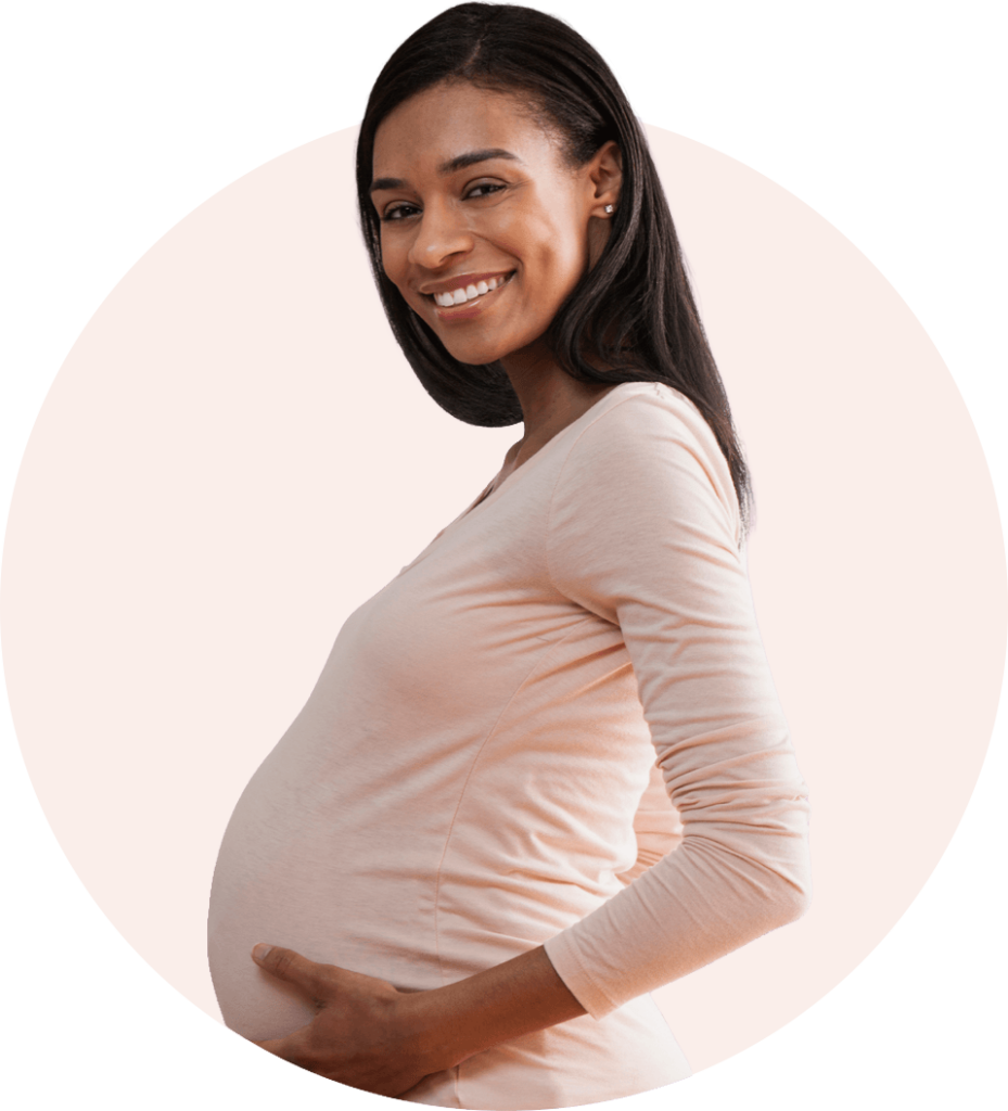 Young black pregnant women holding belly with two hands