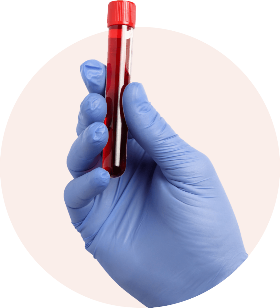 gloved hand holding a tube